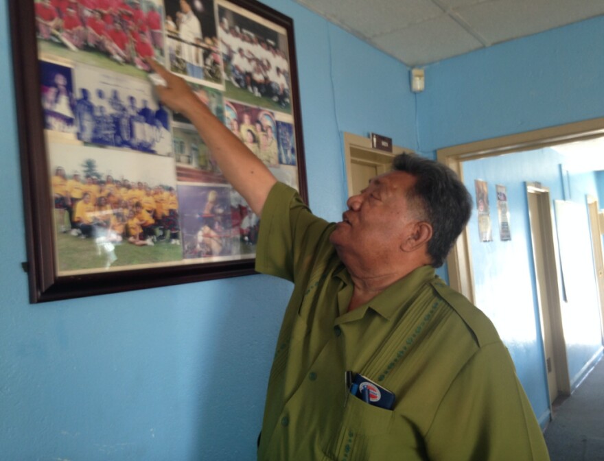 High Chief Loa Pele Faletogo of the Samoan Federation of America in Carson points to old photos from cricket games and other community events. He said sometimes he runs into people he hasn't seen for a while at an event - and learns they have left the neighborhood.