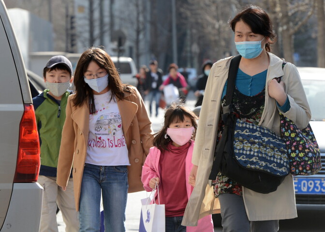 A Chinese family wearing face masks to protect against air pollution walk along a street in Beijing on March 27, 2013. China will more than double the number of cities covered by air quality monitoring, as part of efforts to tackle heavy smog that has sparked huge public anger. Swathes of acrid haze have repeatedly shrouded large parts of the country in recent months, provoking outrage among Internet users and unusually outspoken calls for action in state-run media.