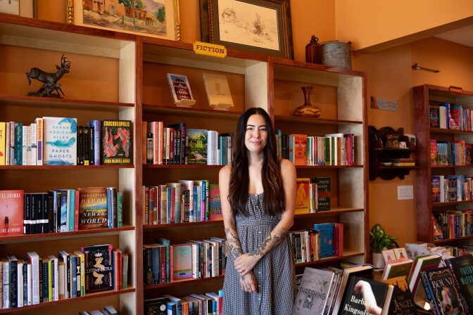 Woman standing in front of bookshelves
