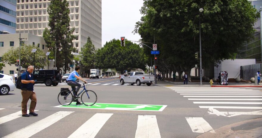 A green left-turn box for bicyclists is seen at a newly marked section of Los Angeles Street in downtown L.A intended to make it easier for pedestrians, bikes and cars to share the road.