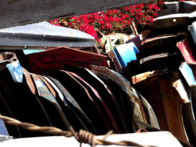 Peeking through the fence at Mustangs Only! at used body panels.