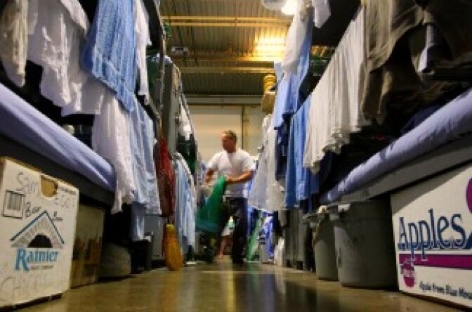 An inmate at the Mule Creek State Prison walks near his bunk bed in a gymnasium that was modified to house prisoners in Ione, California.