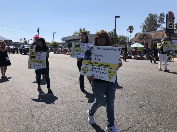 Alma Montero holds a sign in honor of her son, Sebastian. He was hit by a car earlier this year while on his bike in Woodland Hills. He was 15 years old, and dreamed of becoming a marine.