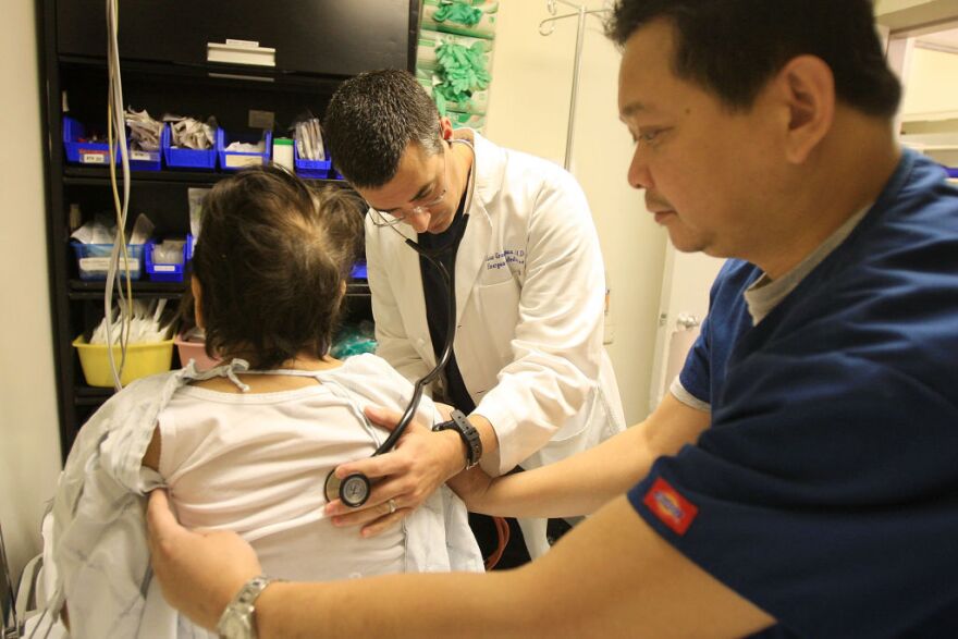 PANORAMA CITY, CA - JANUARY 28:  Dr. Jason Greenspan (L) and emergency room nurse Junizar Manansala care for a patient in the ER of Mission Community Hospital where doctors held a press conference outside on a class action lawsuit against the state of California by a coalition of emergency room physicians claiming that without additional funding, the entire emergency healthcare system is on the verge of collapse on January 28, 2009 in Panorama City, California. According to the coalition, the cost of providing emergency room treatment has nearly doubled over the past decade and patient load increased by more than 28 percent while Medi-Cal reimbursements have remained largely unchanged. During that time, 85 California hospitals in California have closed and an additional 55 facilities have shut down their emergency rooms.  California now reportedly ranks worst in the nation for access emergency care and last in emergency rooms per capita. California has seven emergency rooms per million people while the national average is 20 emergency rooms per million people.  (Photo by David McNew/Getty Images) *** Local Caption *** Junizar Manansala;Jason Greenspan