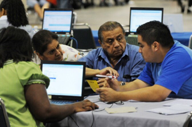 An American family speaks with a bank consultant to restructure their mortgage at the nation's largest loan modification event, which is part of the Neighborhood Assistance Corporation of America's (NACA) 'Save the Dream' tour at the Los Angeles Convention Center, on September 30, 2010. The five-day event, where homeowners can restructure their mortgages to avoid foreclosure, brings together struggling homeowners and major banks.