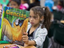 First grader Elizabeth Gatlardo reads a Spanish-language science textbook at George Brown Elementary, a dual-language school in San Bernardino, on Monday morning, May 4, 2015. The Common Core standards come with suggested English-language texts that illustrate the concepts which students need to learn for each standard. Former principal Lorraine Perez says she is not convinced that translating English-language texts would help students’ learning in Spanish.