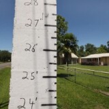 A flood gauge is posted by the road in front of a home May 15, 2011 in Butte LaRose, Louisiana. If the water reaches the flood stage of 27 feet, as predicted, it will be more than half way up the nearby homes.