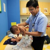 Dr. Hasmukh Amin, a Bakersfield pediatrician, accepts Medi-Cal patients, but says he has to turn away 25-30 people every day who are seeking a pediatrician treating Medi-Cal patients. Here he examines Marcus and Major Thompson.
