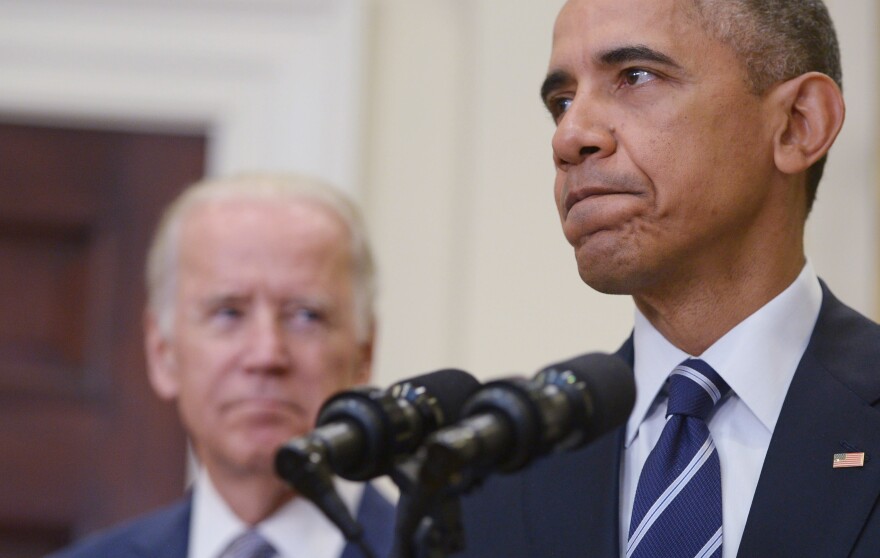 US President Barack Obama speaks on the Keystone XL pipeline, watched by Vice President Joe Biden, on November 6, 2015 in the Roosevelt Room of the White House in Washington, DC. 