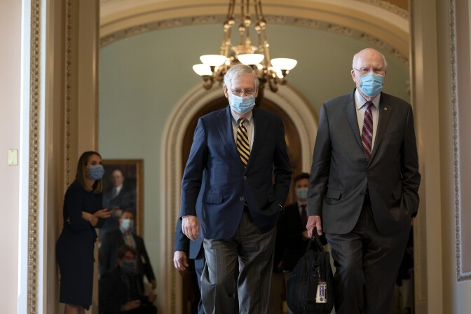WASHINGTON, DC - SEPTEMBER 21: Senate Majority Leader Mitch McConnell (R-KY) (C) and Senator Patrick Leahy (D-VT) (R) wear protective masks as they walk through the U.S. Capitol on September 21, 2020 in Washington, DC. McConnell is planning to hold a vote to fill Justice Ruth Bader Ginsburg's Supreme Court seat, with U.S. President Donald Trump expected to unveil his nominee as early as Friday or Saturday. (Photo by Stefani Reynolds/Getty Images)