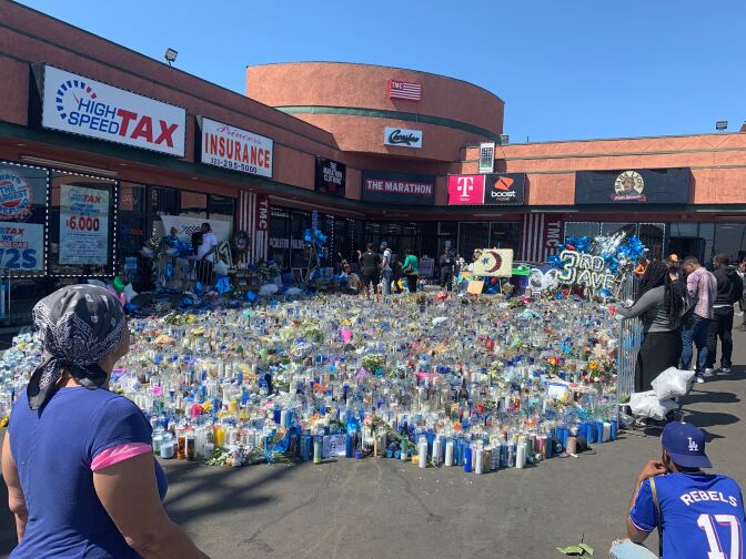 Hundreds stop by the growing memorial for Nipsey Hussle outside his clothing store Marathon, where he was shot and killed in late March. 
