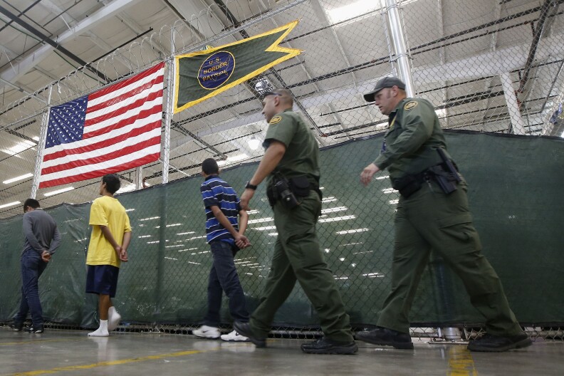 Young detainees being escorted to an area to make phone calls as hundreds of mostly Central American immigrant children are being processed and held at the U.S. Customs and Border Protection Nogales Placement Center in Nogales, Ariz.  