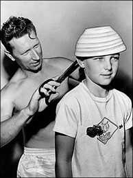 A father (Robert Snyder) gets and the bowl and a pair of oversized scissors to cut the hair of his son Jimmy. The barbers unions in the Los Angeles had voted to raise the cost of haircuts to $1.50, thus leading many to do their own haircuts at home.