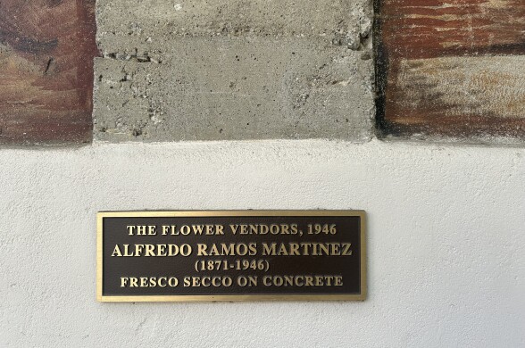 On a wall, a plaque reads: "The Flower Vendors, 1946. Alfredo Ramos Martinez (1871-1946). Fresco secco on concrete."