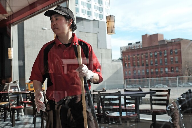 NEW YORK, NY - APRIL 15: A McDonalds employee works in a restaurant on the morning when thousands of people took to the street to demand a minimum wage of $15 an hour on April 15, 2015 in the Brooklyn borough of New York City. In what organizers are calling the biggest ever mobilization of workers in the U.S., thousands of people  across the country staged protests in front of businesses that are paying some of their workers the minimum wage. Home care workers, and employees at Walmart and fast food restaurants say that the current minimum is not a living wage.  (Photo by Spencer Platt/Getty Images)