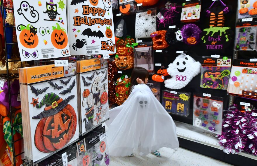A child carries a "ghost" down the aisles while shopping for Halloween merchandise in Alhambra, California on October 23, 2017.
According to a survey from the National Retail Federation which has been conducted annually since 2003, Halloween fans are expected to spend a record $9.1 billion this year, up from the $8.4 billion spent last year. / AFP PHOTO / FREDERIC J. BROWN        (Photo credit should read FREDERIC J. BROWN/AFP/Getty Images)
