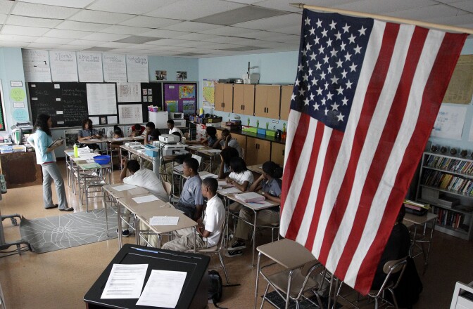 In this May 1, 2012 photo, teacher Kayla Morrow, standing at left, teaches an Advanced Placement government class at the Academy for College and Career Exploration in Baltimore. In May 2012, 2 million students took 3.7 million end-of-year AP exams, figures well over double those from a decade ago 