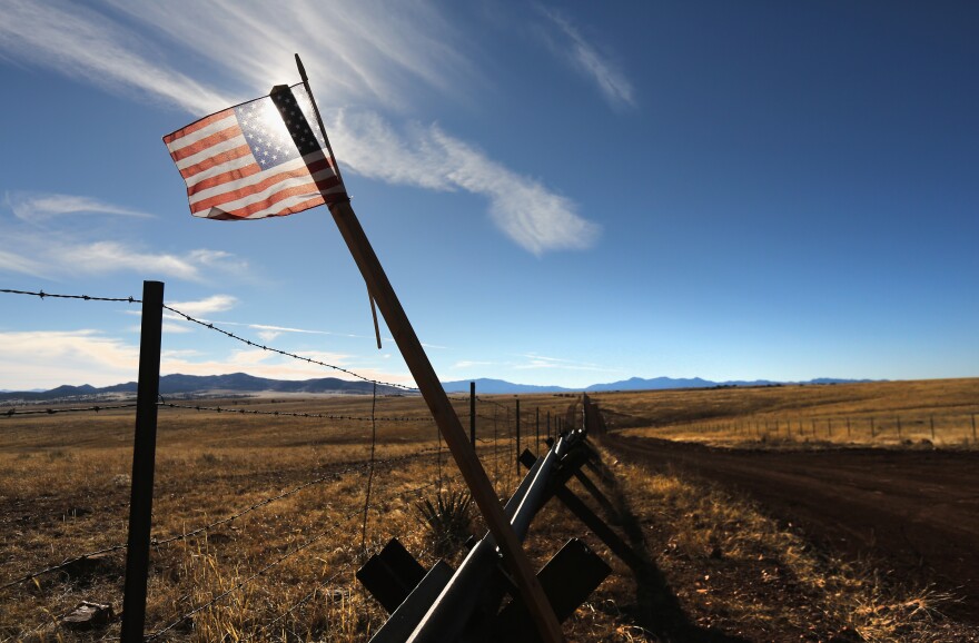 SONOITA, AZ - FEBRUARY 26:  An American flag flies at the U.S.-Mexico border on February 26, 2013 near Sonoita, Arizona. The Federal government has increased the Border Patrol presence in Arizona, from some 1,300 agents in the year 2000 ro 4,400 in 2012. The apprehension of undocumented immigrants crossing into the U.S. from Mexico has declined during that time from 600,016 in 2000 to 123,000 in 2012.  (Photo by John Moore/Getty Images)