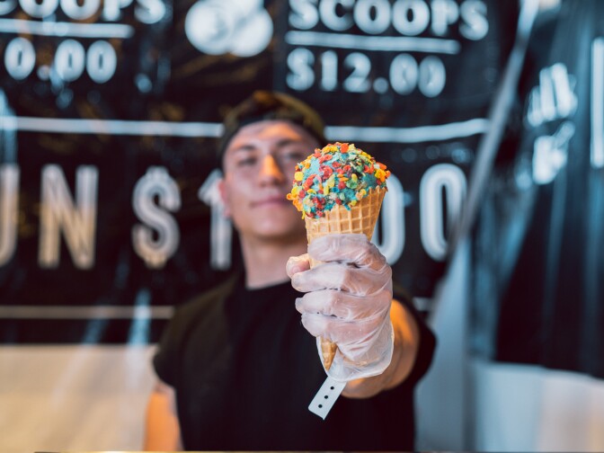 A vendor serves an ice cream cone at EEEEEATSCON.
