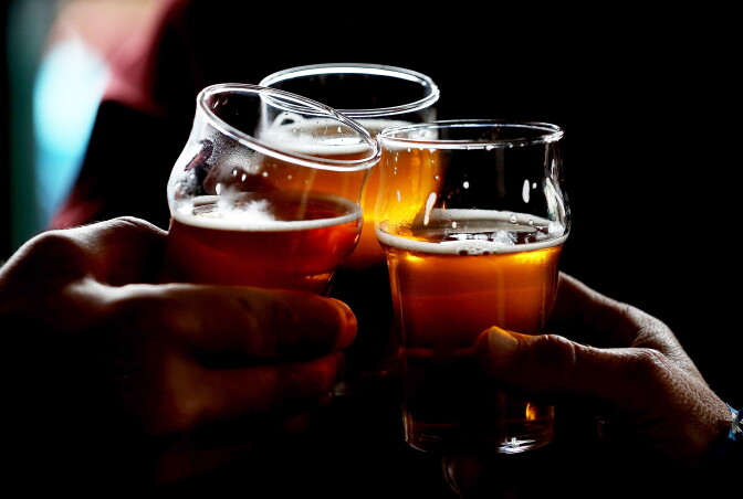 Russian River Brewing Company customers clink their glasses while drinking the newly released Pliny the Younger triple IPA beer on February 7, 2014 in Santa Rosa, California.