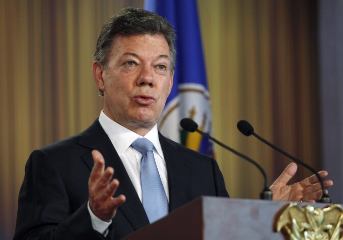 Colombia's President Juan Manuel Santos speaks at a joint press conference with OAS chief Jose Miguel Insulza about a regional study on the illicit drug trade, presented by Insulza to Santos at the Presidential Palace in Bogota, Colombia, Friday, May 17, 2013. The  $2.2 million study which emphasizes drug abuse as primarily a public health issue, makes no firm recommendations, instead suggesting several possible ways to stem the illicit drug trade, which has fueled violent crime and corruption and even destabilized governments. 