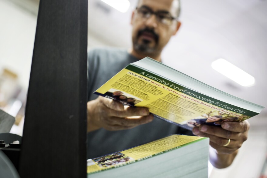Lucio Sandoval inserts campaign mailers into an address printer at Mellady Direct Marketing in Santa Clarita, Calif. on Thursday morning, Oct. 6, 2016.