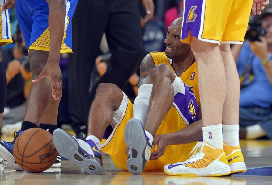 Los Angeles Lakers guard Kobe Bryant grimaces after being injured during the second half of their NBA basketball game against the Golden State Warriors, Friday, April 12, 2013, in Los Angeles. The Lakers won 118-116.