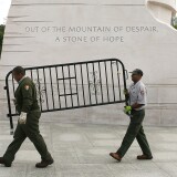 WASHINGTON, DC - OCTOBER 17:  U.S. Park Service workers carry a barricade that was used to close the Martin Luther King Memorial on the morning after a bipartisan bill was passed by the House and the Senate to reopen the government and raise the debt limit, on October 17, 2013 in Washington, DC. President Obama signed the bill into law, that will fund the government until January 15, 2014 and allow the government to pay bills until February 7, 2014.  (Photo by Mark Wilson/Getty Images)