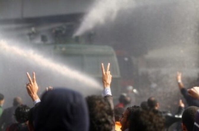 Egyptian demonstrators confront riot police during a demonstration in Cairo on January 28, 2011, demanding the ouster of President Hosni Mubarak.
