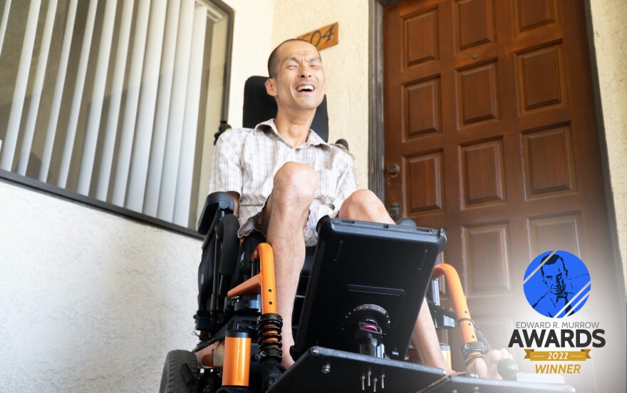 Tim Jin in his wheelchair in front of the door to his apartment in Orange County.