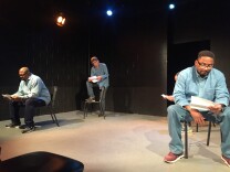 Derrick Hill and Kentrell Antoine act out a scene in "A Man Like Me" where men in jail read and write letters to loved ones outside. 