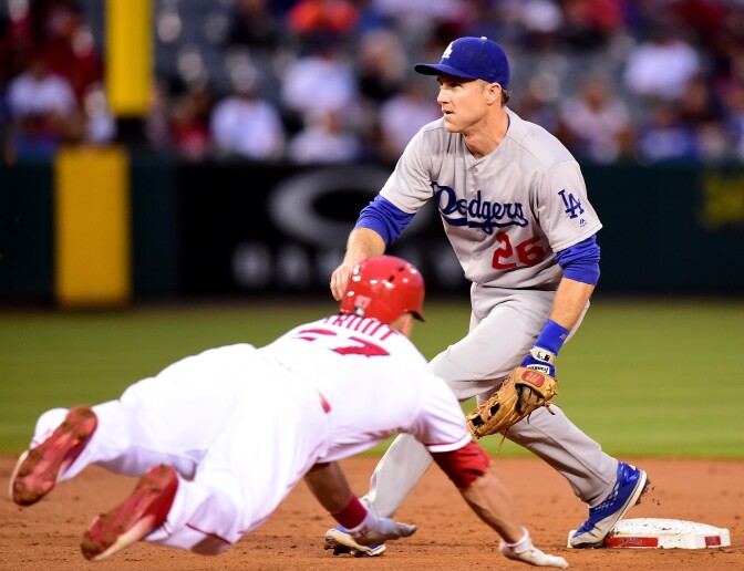 ANAHEIM, CA - MAY 19:  Mike Trout #27 of the Los Angeles Angels steals second base as Chase Utley #26 of the Los Angeles Dodgers waits for the throw during the first inning at Angel Stadium of Anaheim on May 19, 2016 in Anaheim, California.  (Photo by Harry How/Getty Images)