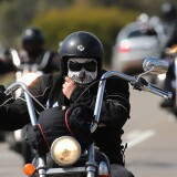 PERTH, AUSTRALIA - SEPTEMBER 12: A Rebels motorcycle club member rides from Meckering to Perth on September 12, 2013 in Perth, Australia. An estimated 1000 Rebels from chapters all over Australia gather for the road trip across the country to Perth.  (Photo by Paul Kane/Getty Images)