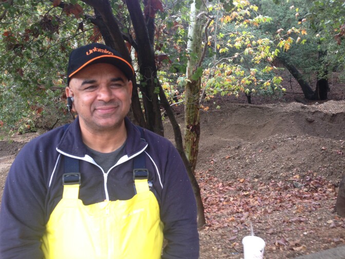 Homeowner Gary Bains was clearing mud and a pathway for Stormwater at 2 a.m. Wednesday morning, Dec. 3, 2014 with the help of city road crews. 