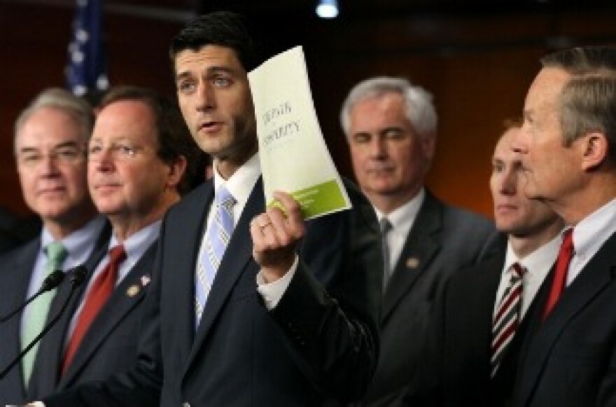 Flanked by other congressional members, U.S. Rep. Paul Ryan (R-WI) (C), chairman of the House Budget Committee, holds up a copy of the 2012 Republican budget proposal during a news conference April 5, 2011 on Capitol Hill in Washington, DC.