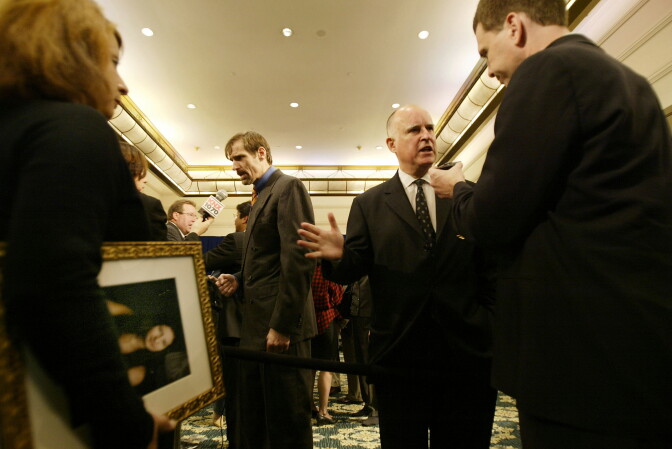 Former California governor Jerry Brown (2nd R) converses with Dr. Henry Nichols (2nd L), whose sister was murdered by a "Three Strikes" felon, after a news conference to oppose state Proposition 66, on Oct. 28, 2004 in L.A., Calif. Prop 66 proposed harsher modifications to the Three Strikes law than the current ballot initiative, and a Field Poll showed California citizens may be ready to make amends to the crime law.