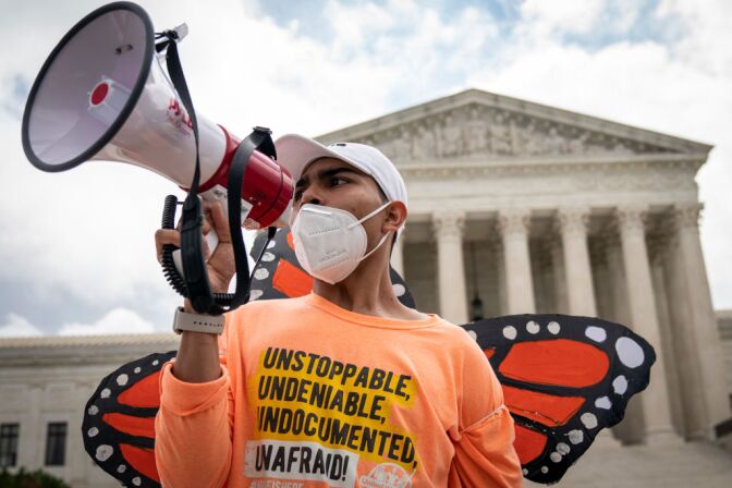 WASHINGTON, DC - JUNE 18: Roberto Martinez, a DACA recipient, chants and cheers following the Supreme Court's decision regarding the Trump administration's attempt to end DACA outside the U.S. Supreme Court on June 18, 2020 in Washington, DC. On Thursday morning, the Supreme Court, in a 5-4 decision, denied the Trump administration's attempt to end DACA, the Deferred Action for Childhood Arrivals program. (Photo by Drew Angerer/Getty Images)