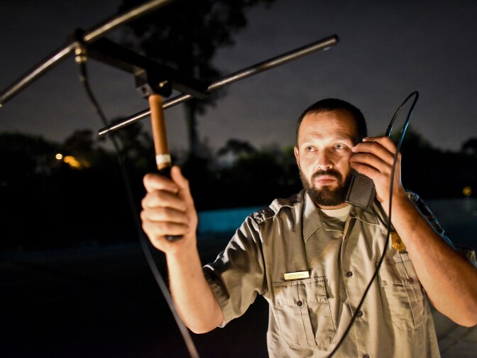 NPS Ecologist Justin Brown uses a handheld antenna and scanner to listen for signals from radio-collared coyotes living near downtown Los Angeles late Wednesday night, June 3rd. 

National Park Service Ecologist Justin Brown tracks coyotes living near downtown Los Angeles late Wednesday night June 3 and early Thursday morning June 4, 2015, in Los Angeles, CA. Some of the coyotes are fitted with radio collars.