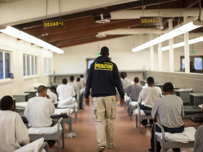 A probation officer walks through a dormitory at Camp Afflerbaugh.