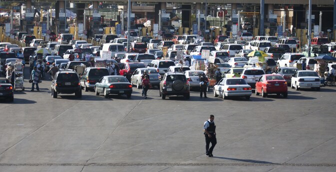 A member of the US Border Patrol walks behind the line of cars at the San Ysidro gate at the border between Mexico and United State in Tijuana, Mexico on May 04, 2011, after  the US military operation that ended in the killing of Al-Qaeda's mastermind, Osama Bin Laden. Though Mexico's government has not announced special security measures after the US commando raid in Pakistan claimed the life of the world's most wanted man, there was close cooperation with US authorities to check for potentially dangerous persons.   AFP PHOTO / FRANCISCO VEGA (Photo credit should read FRANCISCO VEGA/AFP/Getty Images)