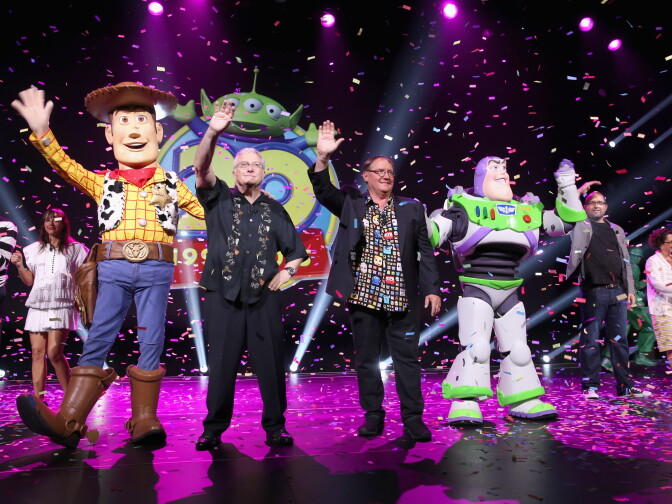Composer Randy Newman of "Toy Story" 1, 2 and 3 and director John Lasseter of "Toy Story 4" (C) took part in "Pixar and Walt Disney Animation Studios: The Upcoming Films" presentation at Disney's D23 Expo 2015 in Anaheim.