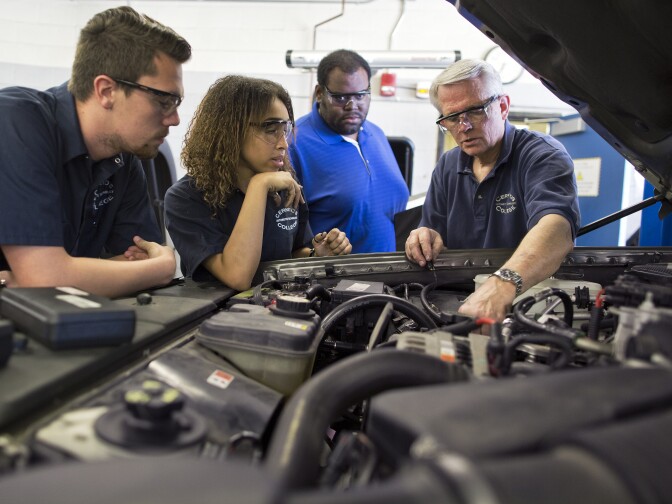 Automotive instructor Jon Bender works with students Michael Asendorf, left, Kayla Alves and Kevin Armand during a Ford break, steering and suspension class at Cerritos College on Wednesday, Feb. 11.