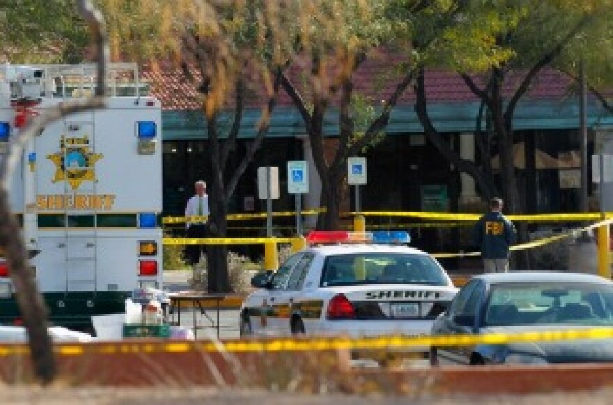 An FBI agent investigates the crime scene in front of the Safeway store a day after a person opened fire on a group of people on January 9, 2011 in Tucson, Arizona.