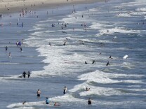 File: Swimmers enjoy waters of Pacific near the famous Santa Monica Pier on Aug. 20, 2013.