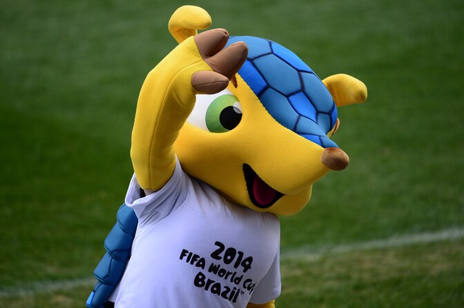 Official mascot of the 2014 FIFA World Cup Brazil Fuleco the Armadillo waves during a training session of Italian football team at the Vicente Calderon stadium in Madrid on March 4, 2014 on the eve of their World Cup 2014 friendly football match against Spain.