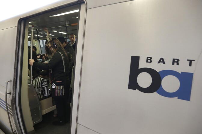 Bay Area Rapid Transit passengers wait for a BART train to depart the Fruitvale station in Oakland, Calif. San Francisco Bay Area officials say a 2nd University of California, Berkeley, student infected with measles could have exposed thousands of others by attending classes and riding public transit. 