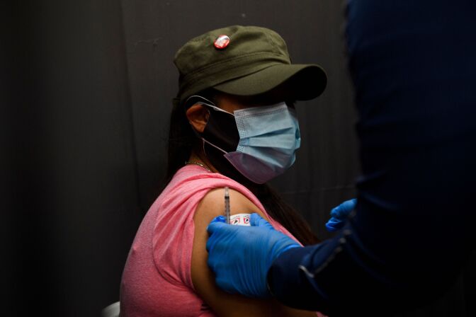 Farm worker Carolina Sanchez receives a dose of Covid-19 vaccine at a vaccination site organized by the United Farm Workers (UFW), Kern Medical, and the Kern County Latino Covid-19 Task Force inside Reuther Hall at Forty Acres on March 13, 2021 in Delano, California. - Central Valley farm workers were administered the vaccines free of charge, regardless of insurance or immigration status. (Photo by Patrick T. FALLON / AFP) (Photo by PATRICK T. FALLON/AFP via Getty Images)