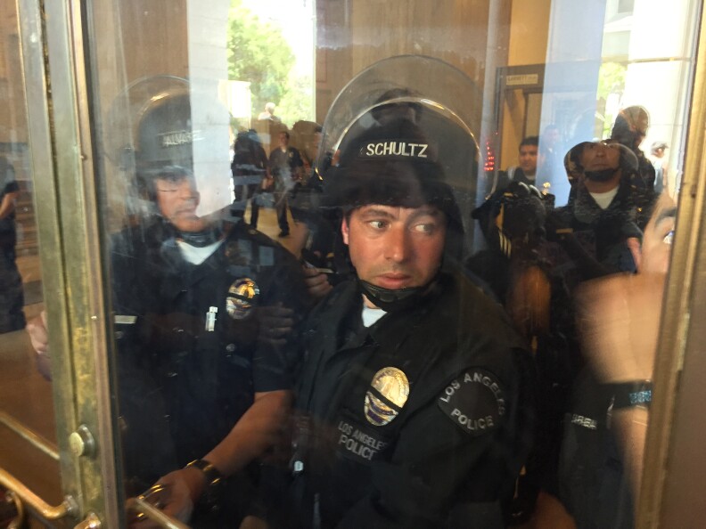 Police in riot gear keep protesters out of City Hall on Tuesday, July 12, 2016. The protesters marched from police headquarters to City Hall after the Board of Police Commissioners ruled that officers acted "within policy" in the fatal shooting of Redel Kental Jones, 30, in August 2015.