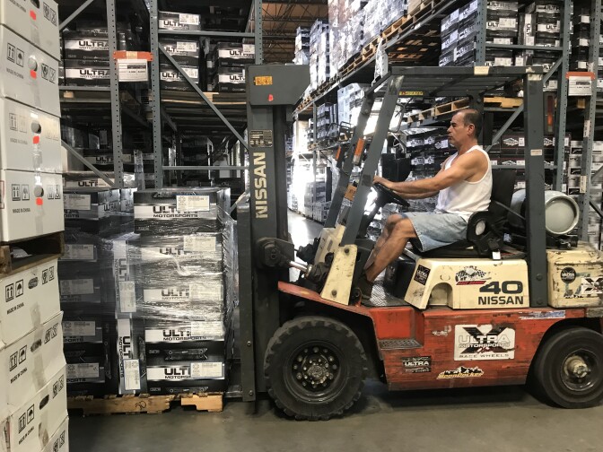 A forklift driver moves boxes of wheels in the warehouse of Fullerton-based company Ultra Wheel, Sept. 20, 2018. 