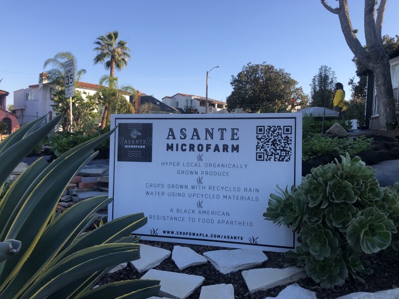 A picture of a sign that has information about Asante Microfarm